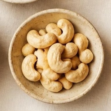 Whole cashew kernels in a ceramic bowl