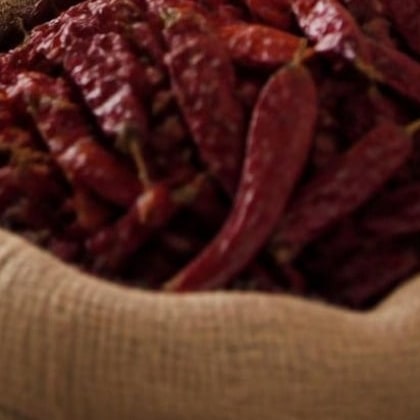 Whole dried red chillies in a jute sack